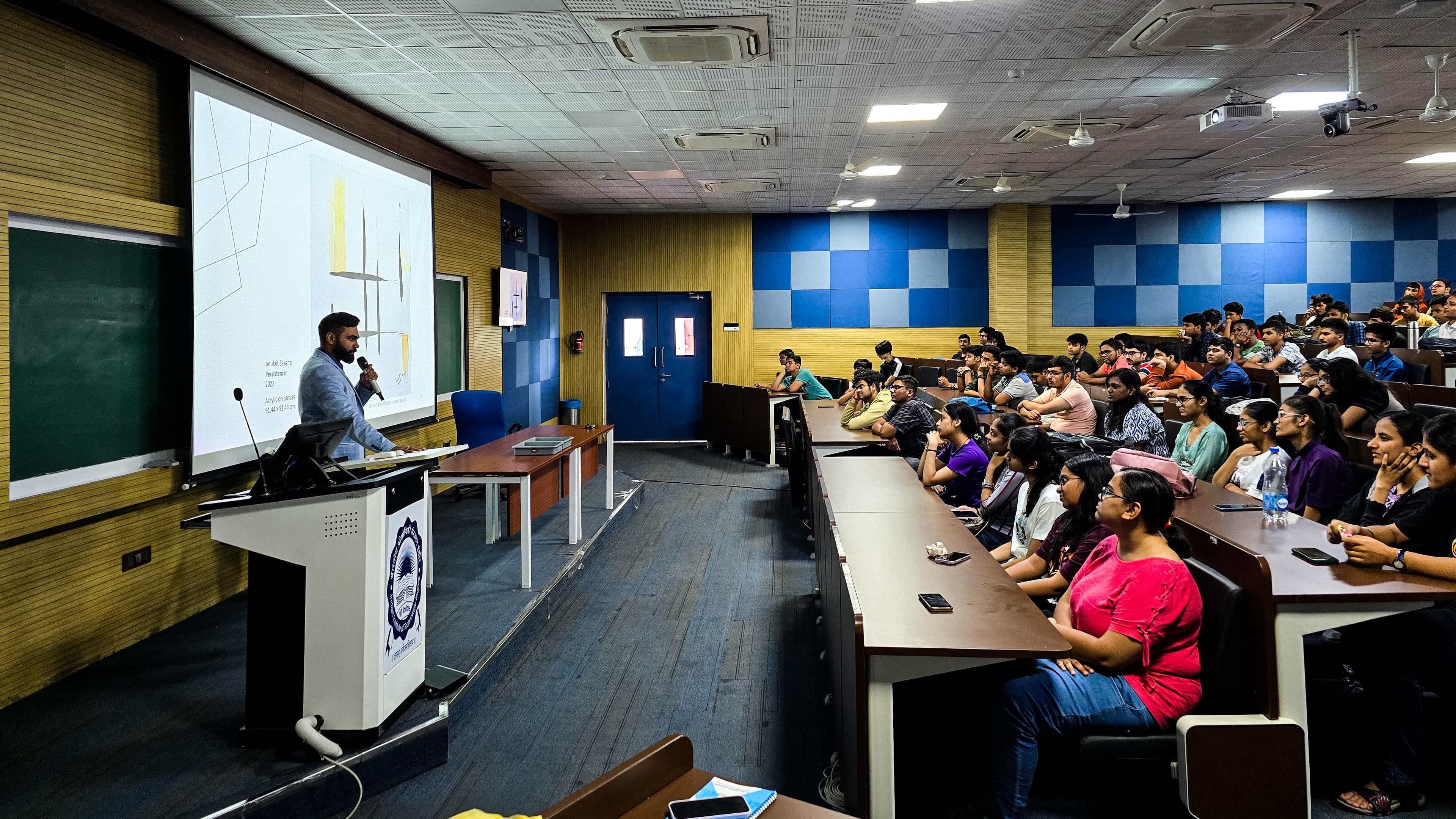 Anukrit Saxena teaching art concepts at a classroom board
