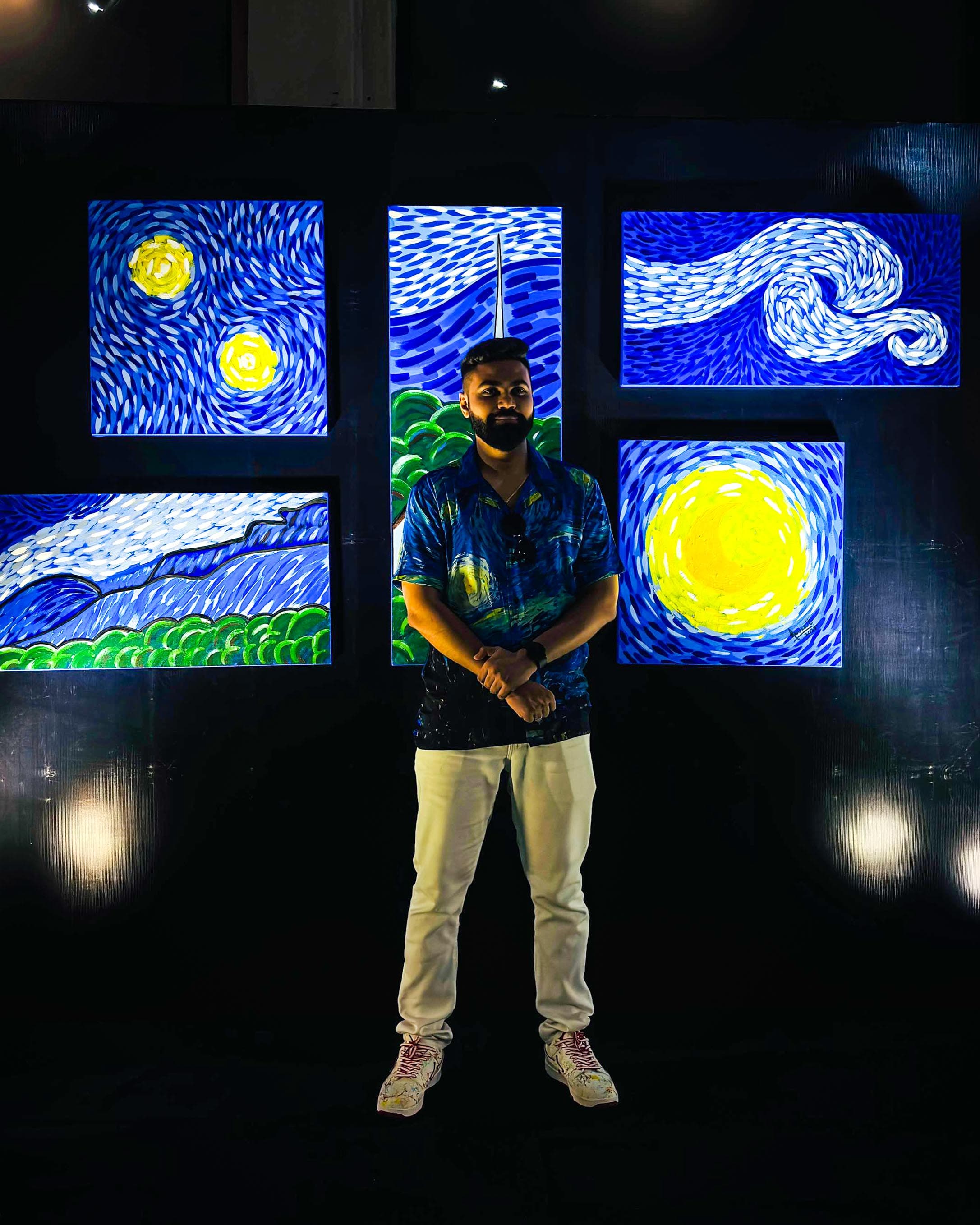 Illuminated blue and yellow artworks in an exhibition display